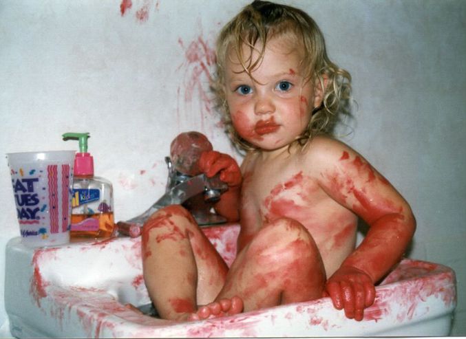 Un enfant s'est amusé avec du rouge à lèvres dans un évier de salle de bain.