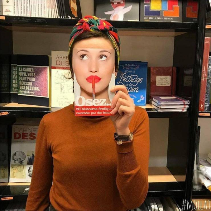 Un libraire s'amuse à photographier ses clients avec des livres.