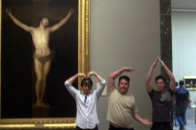 Trois personnes forment le fameux YMCA en s'aidant du christ en croix
