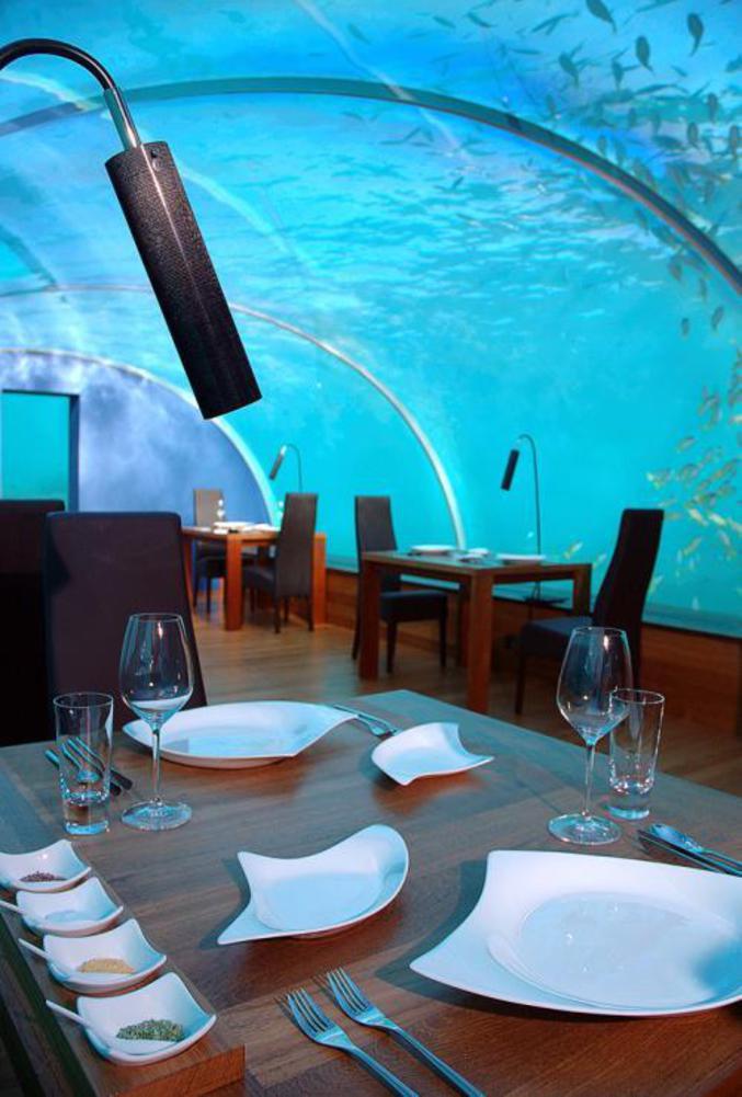 Un restaurant entouré d'eau et de poissons.